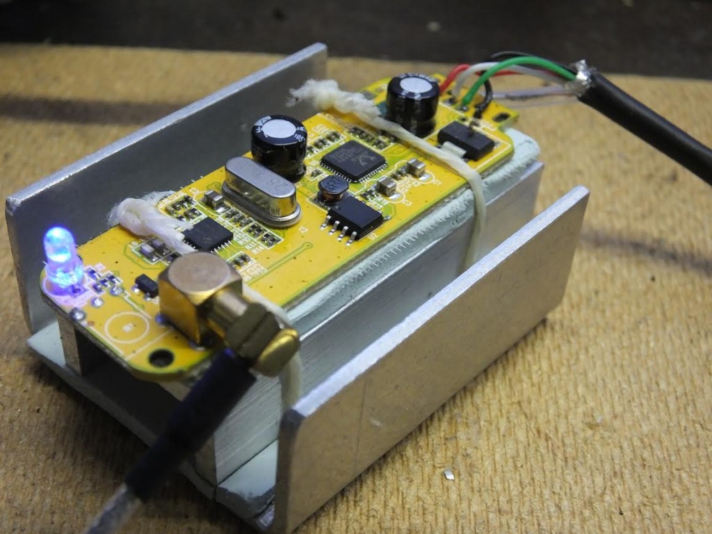 Inside latest SDR / Latest SDR - "This is my latest version using a R820T2 version, and I have also fitted this with a TCXO. In this version I also used a 1Mohm and 47nF to ground the USB shield wire as in a previous post. This version only uses one metal spacer and the end  of the PCB is secured by two M2 nylon screws / nuts. Case from China RF on Ebay."