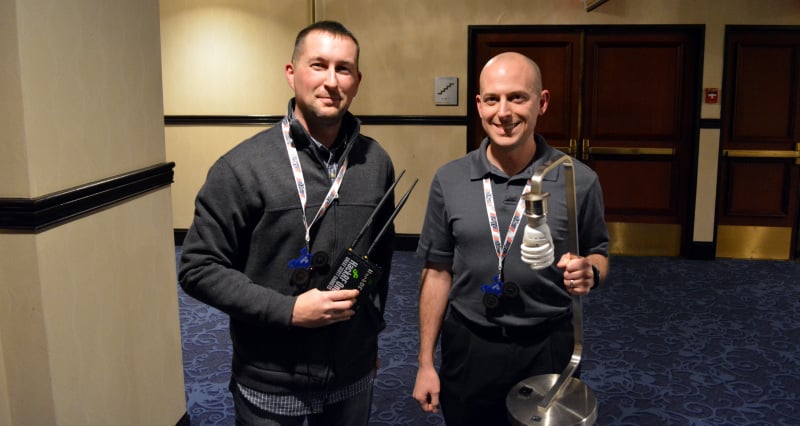 Joseph and Ben holding a HackRF and z-wave controlled light.